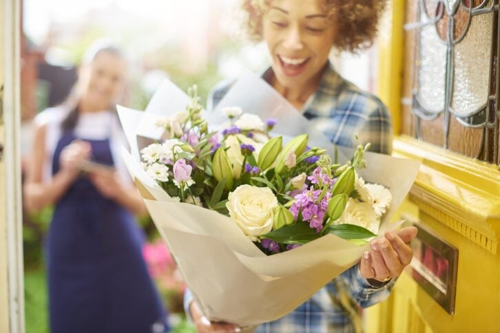 woman getting flower delivery at her door