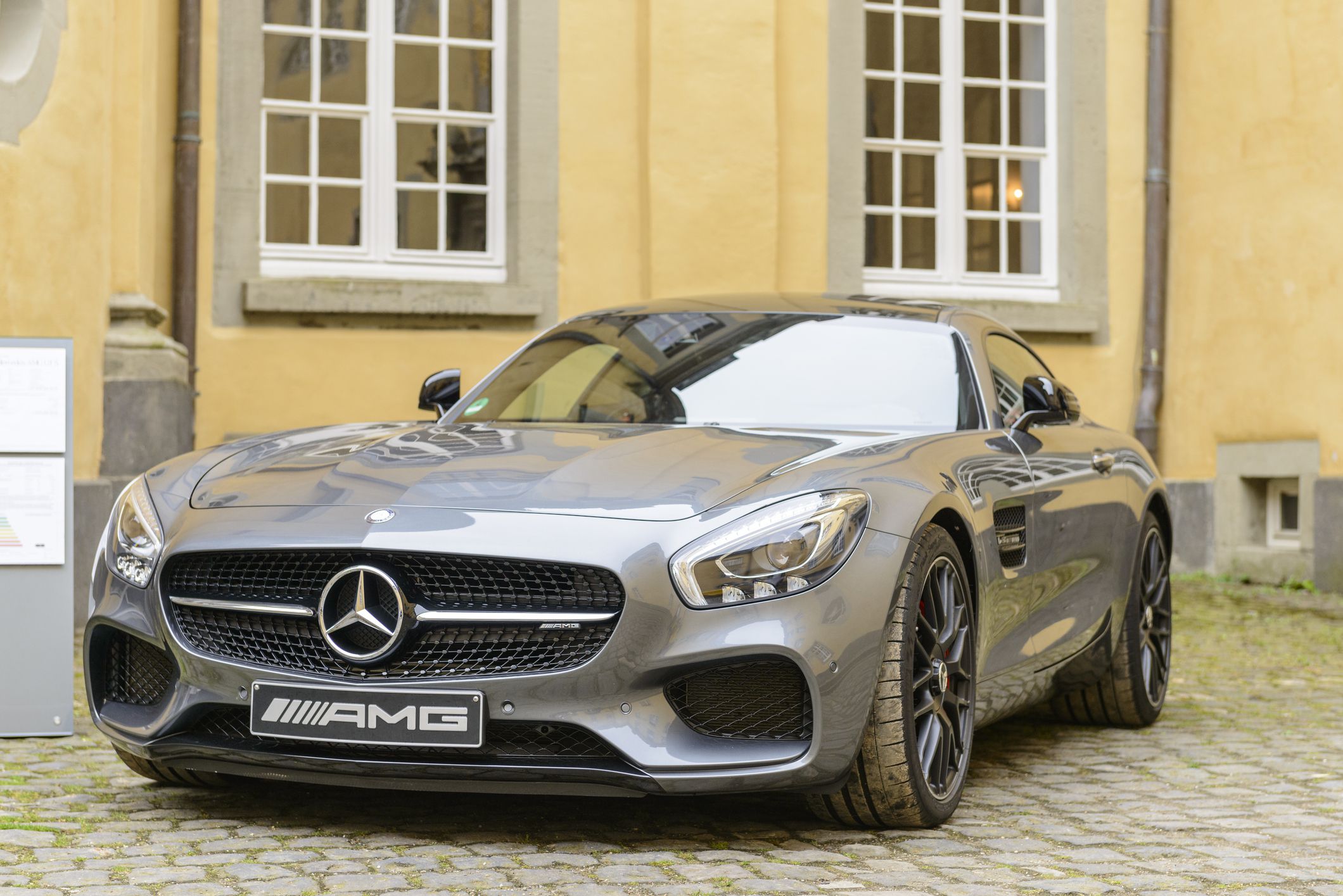 Jüchen, Germany - August 5, 2016: Gray Mercedes-AMG GT coupe performance sports car front view. The Mercedes AMG GT is powered by a front-mid mounted 4-litre twin-turbo V8. The car is on display during the 2016 Classic Days at castle Dyck.
