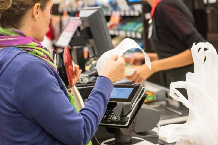 woman electronic signing her bill at the supermarket