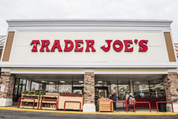 Fairfax, USA - November 25, 2016: Trader Joes grocery store facade with sign and items on display and people walking