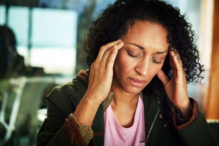 mixed-race woman with migraine headache