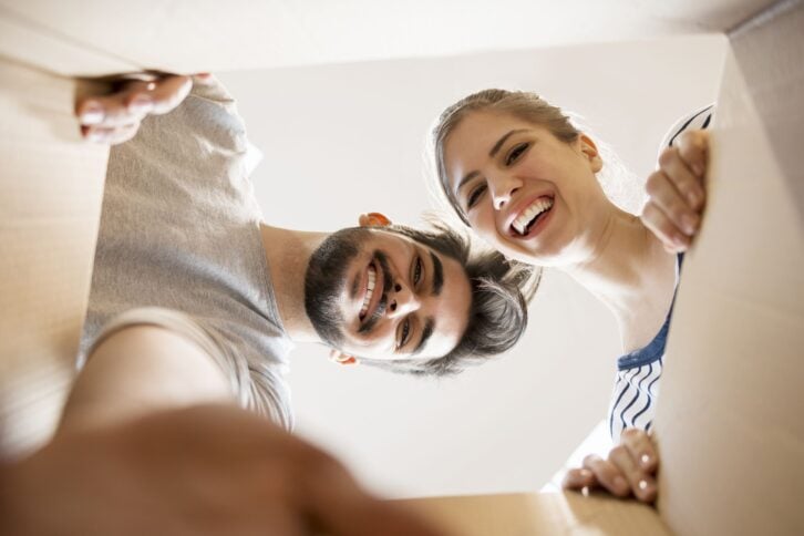 young couple looking into the box