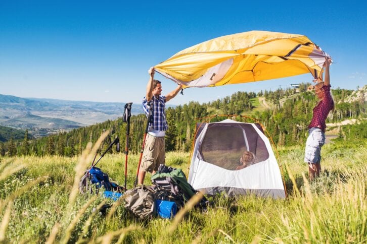 family setting up tent