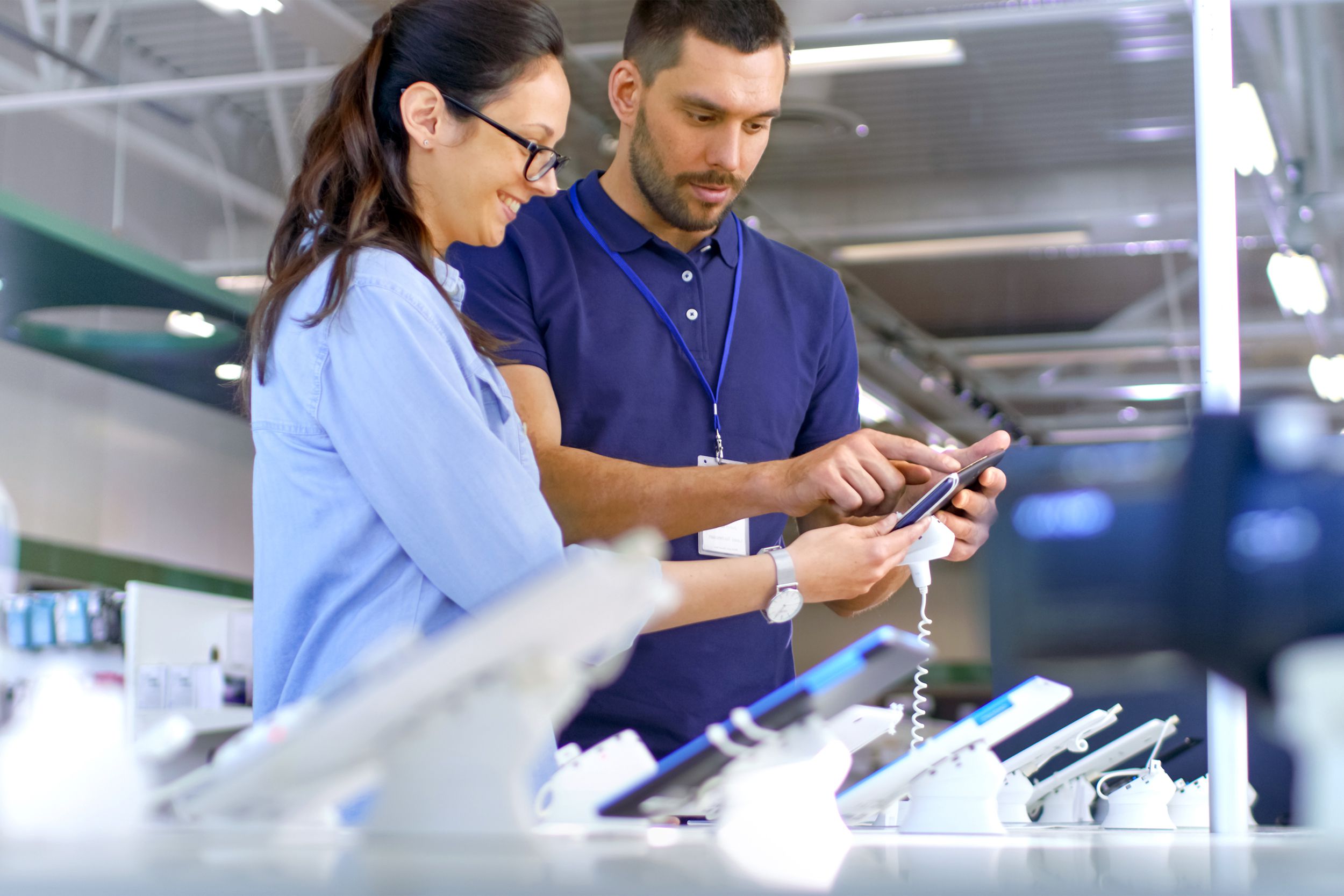 electronics store customer buying smartphone