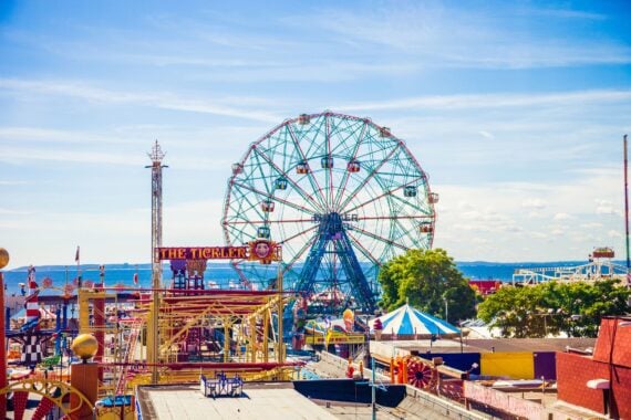 New York, USA -August 29th, 2014: Aerial view of Coney Island amusement park, on the left side is visible a section of the famous Cyclone Rollercoaster, on the right side all the rest of the park during an hot summer day.
