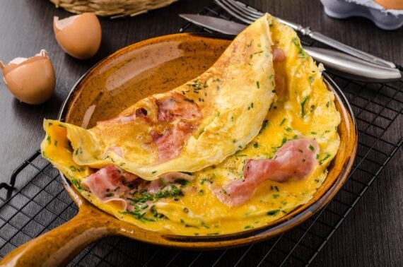Ham and egg omelette, delicious and simple with fresh bread and herbs chive