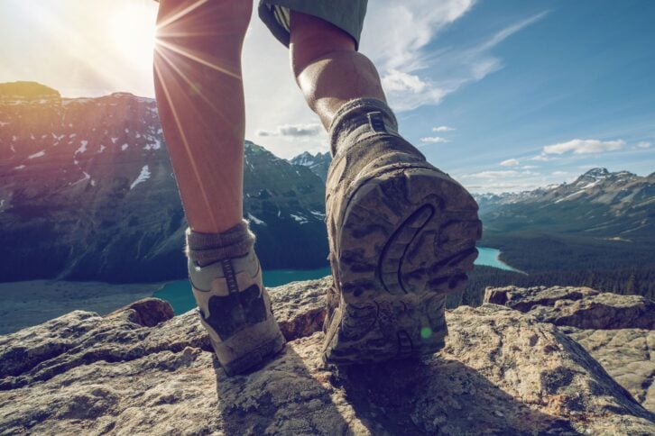 detail of hiker on ridge, close up on hiking boots