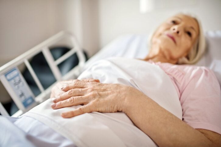 senior woman lying in bed