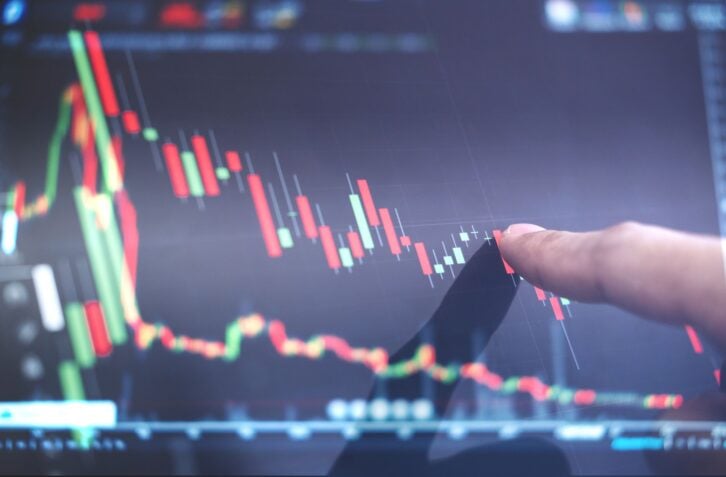 Finger pointing on stock exchange market chart