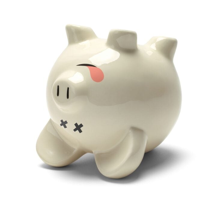 Upside Down Dead Piggy Bank Isolated on White Background.