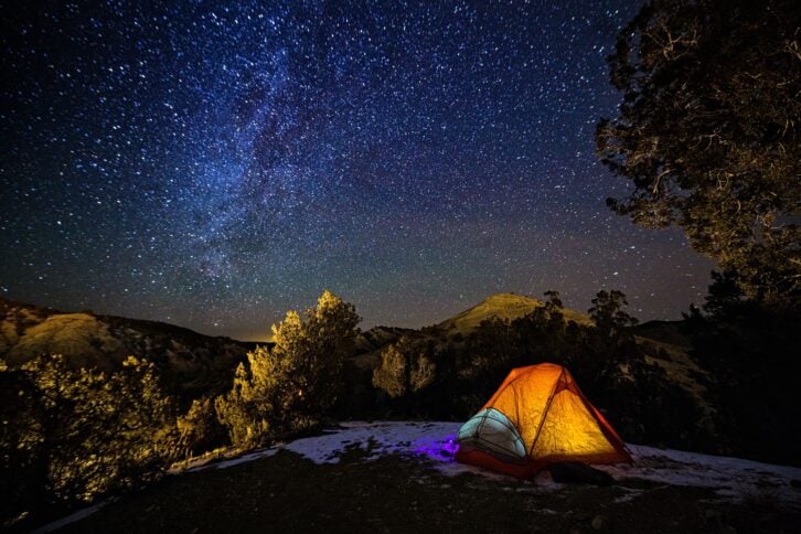 camping in a tent under the stars and Milky Way Galaxy