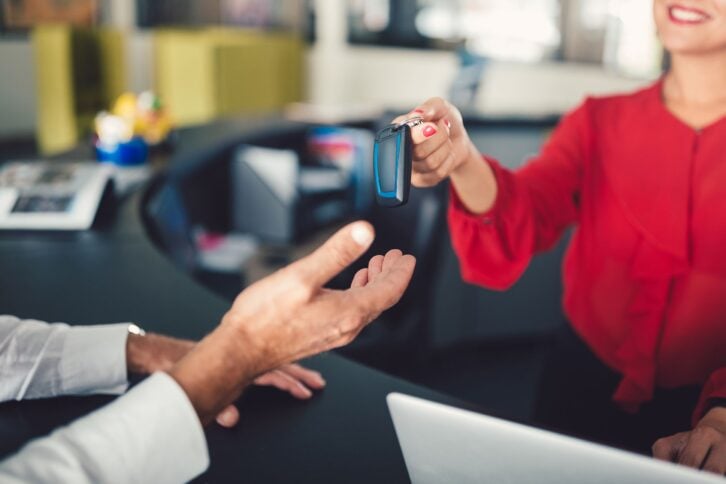 rental agent giving car keys to customer