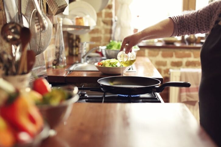 cooking vegetables in real, rustic kitchen. Natural light, short DOF, a little bit noisy.