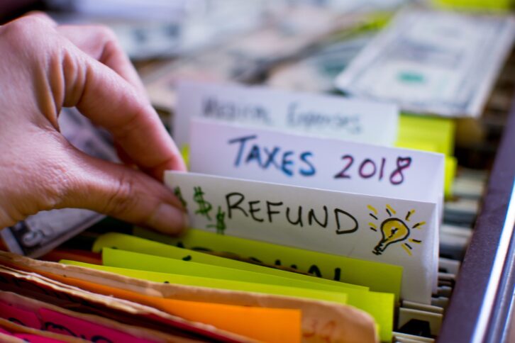 woman pulling out file on tax season 2018 tax refund