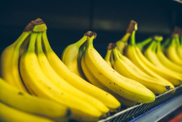 bananas branch on shelf of store. shopping concept