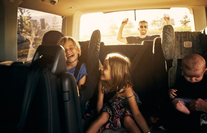 Shot of adorable little children sitting in a car