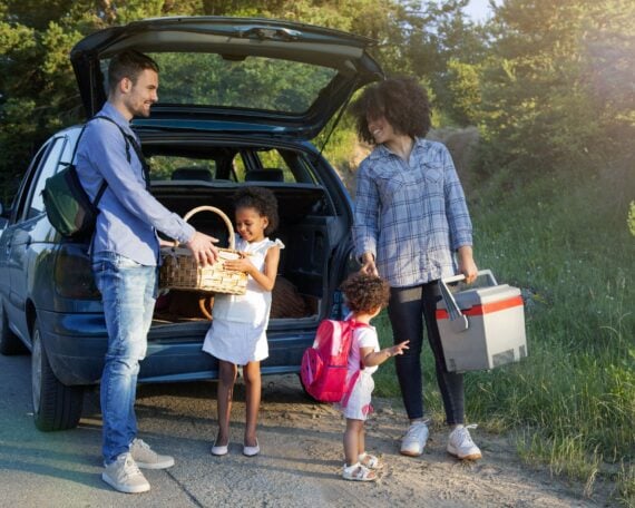 family unloading summer items from car