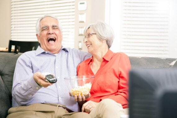senior couple watching tv at home