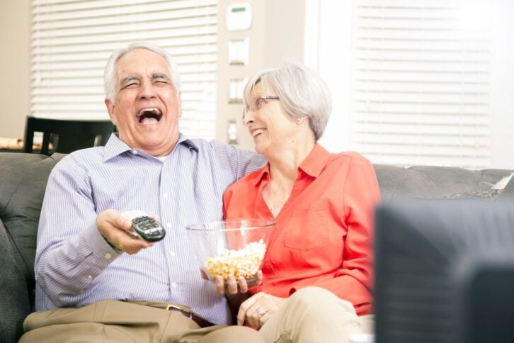 senior couple watching tv at home