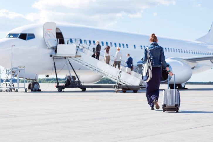 woman walking towards the airplane