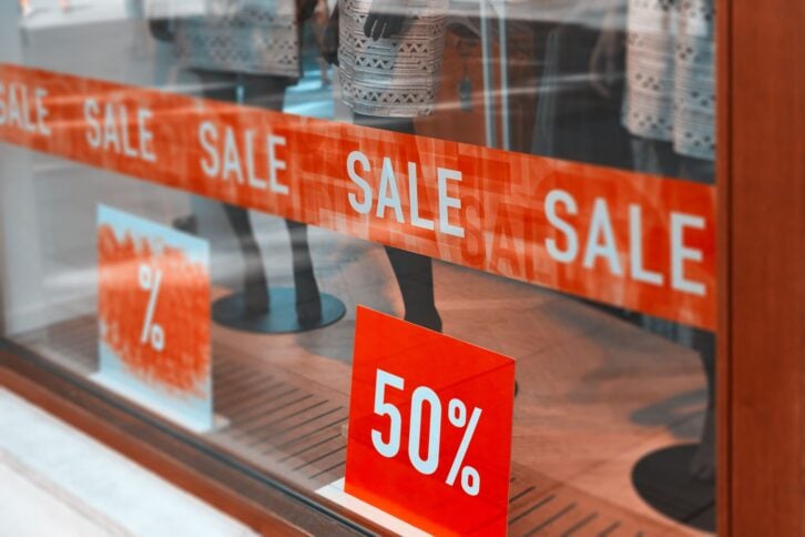 store window at sale with 50%.red banner on the window.