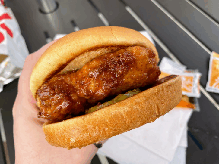 A Chick-Fil-A sandwich with sauce on the chicken