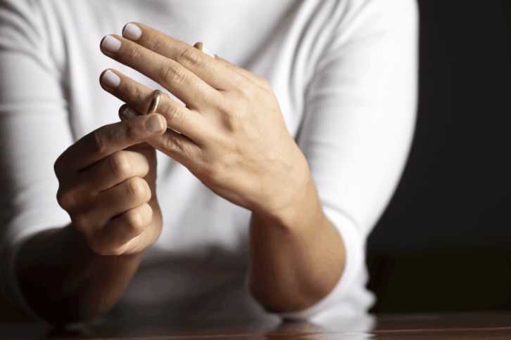 woman taking off wedding ring