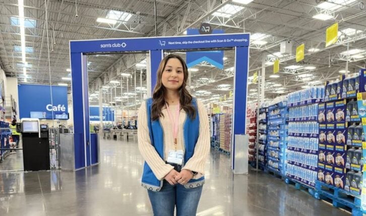 Woman standing at AI checkout stations at a Sam's Club