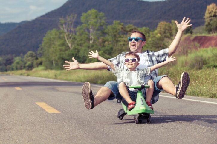 Father and son playing on the road
