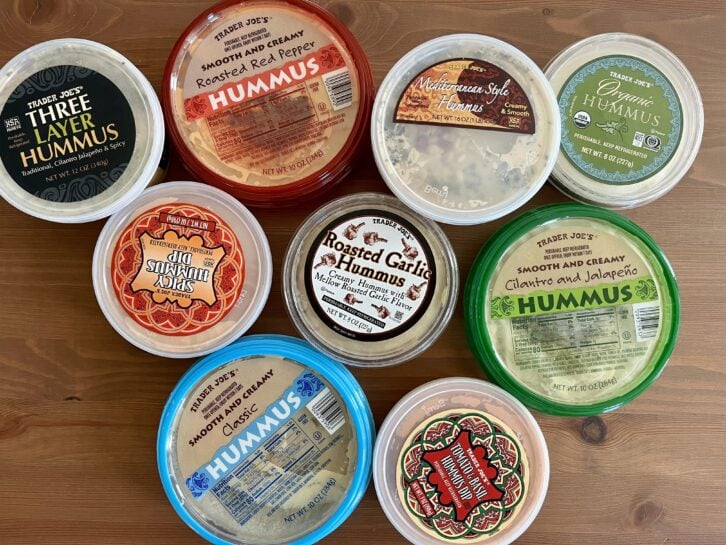 nine flavors of trader joes hummus on a table