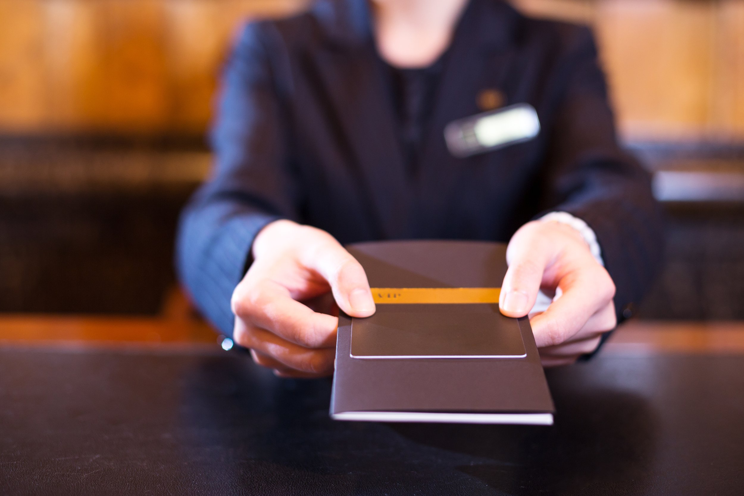 Hotel clerk handing bill over the counter