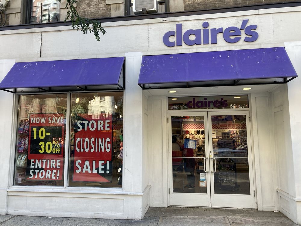 A Claire's store with a purple awning displays large signs in the window reading "STORE CLOSING SALE!" and "NOW SAVE 10-30% OFF ENTIRE STORE!" The entrance is open and the store interior is visible.