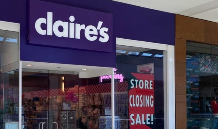 Storefront of Claire’s in a mall, with a large purple sign above the entrance and a red sign in the window that reads "Store Closing Sale!" The store interior is visible through glass doors.