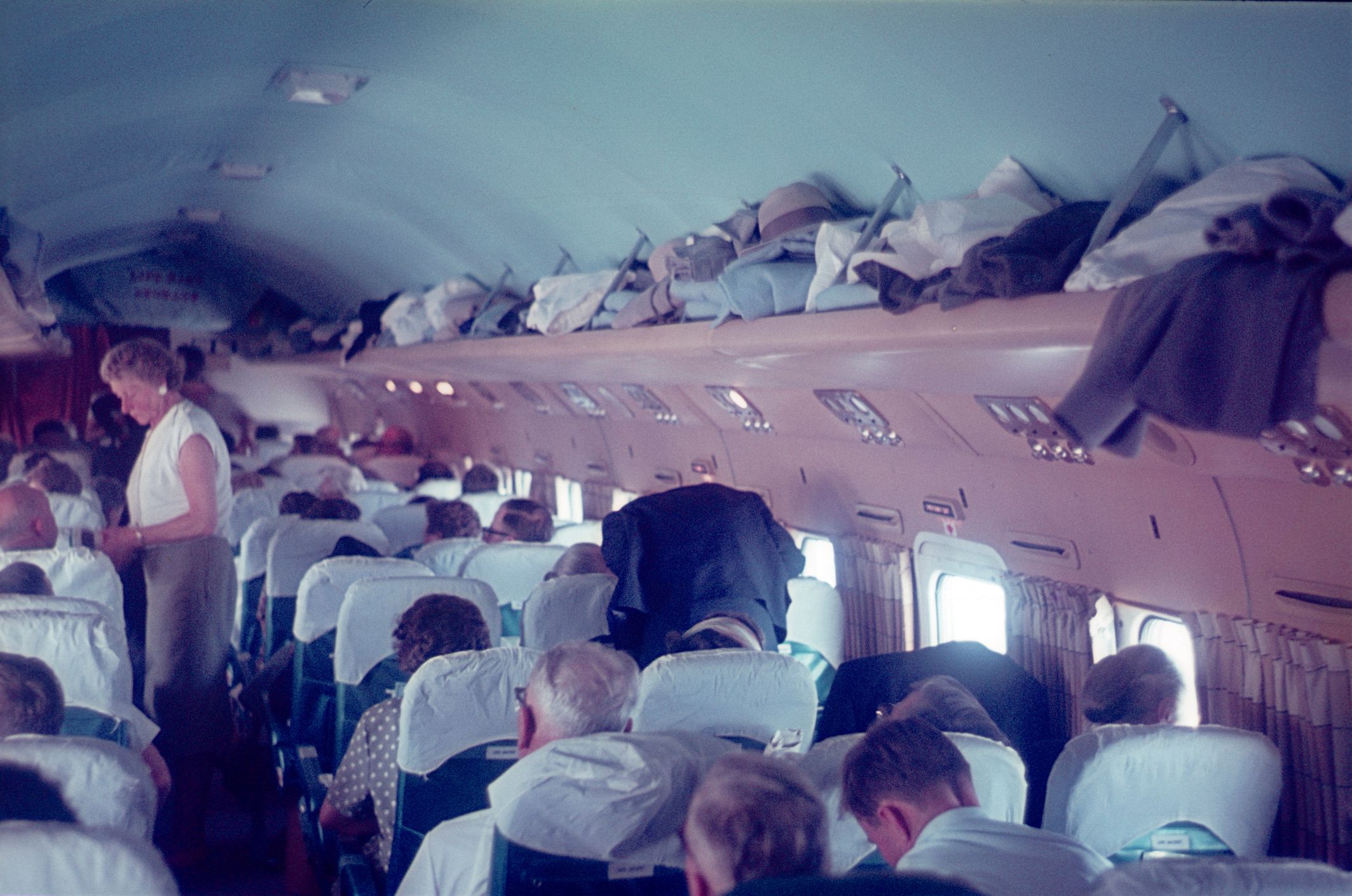 United States, 1962. Riddler Air airliner with passengers on a domestic flight over the US at 8000 meters altitude.
