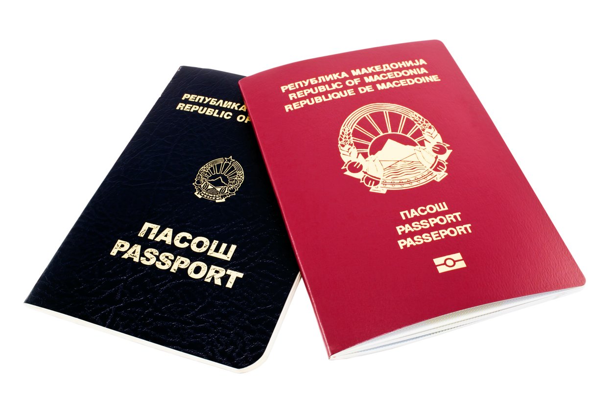 Two passports from North Macedonia, one black and one red, both featuring the country's emblem and text in Macedonian and English, shown on a white background.