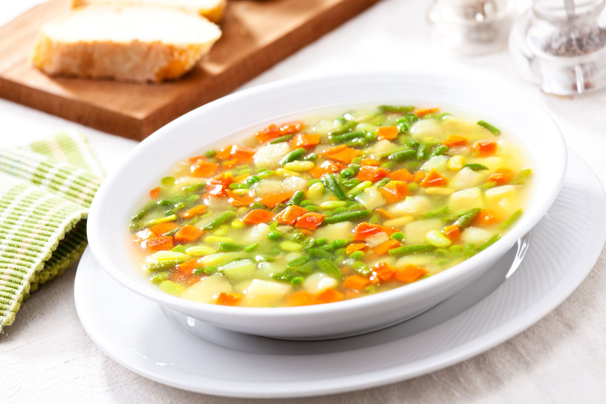 Bowl of homemade soup with chopped organic vegetables