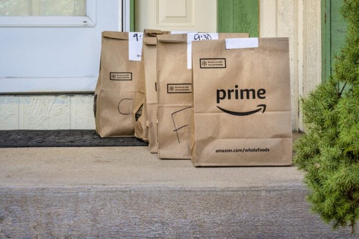Fort Collins, CO, USA - March 31, 2020: Brown bags with groceries and fresh produce delivered to house from Whole Food Market and order through Amazon Prime. Online shopping during coronavirus pandemic concept.