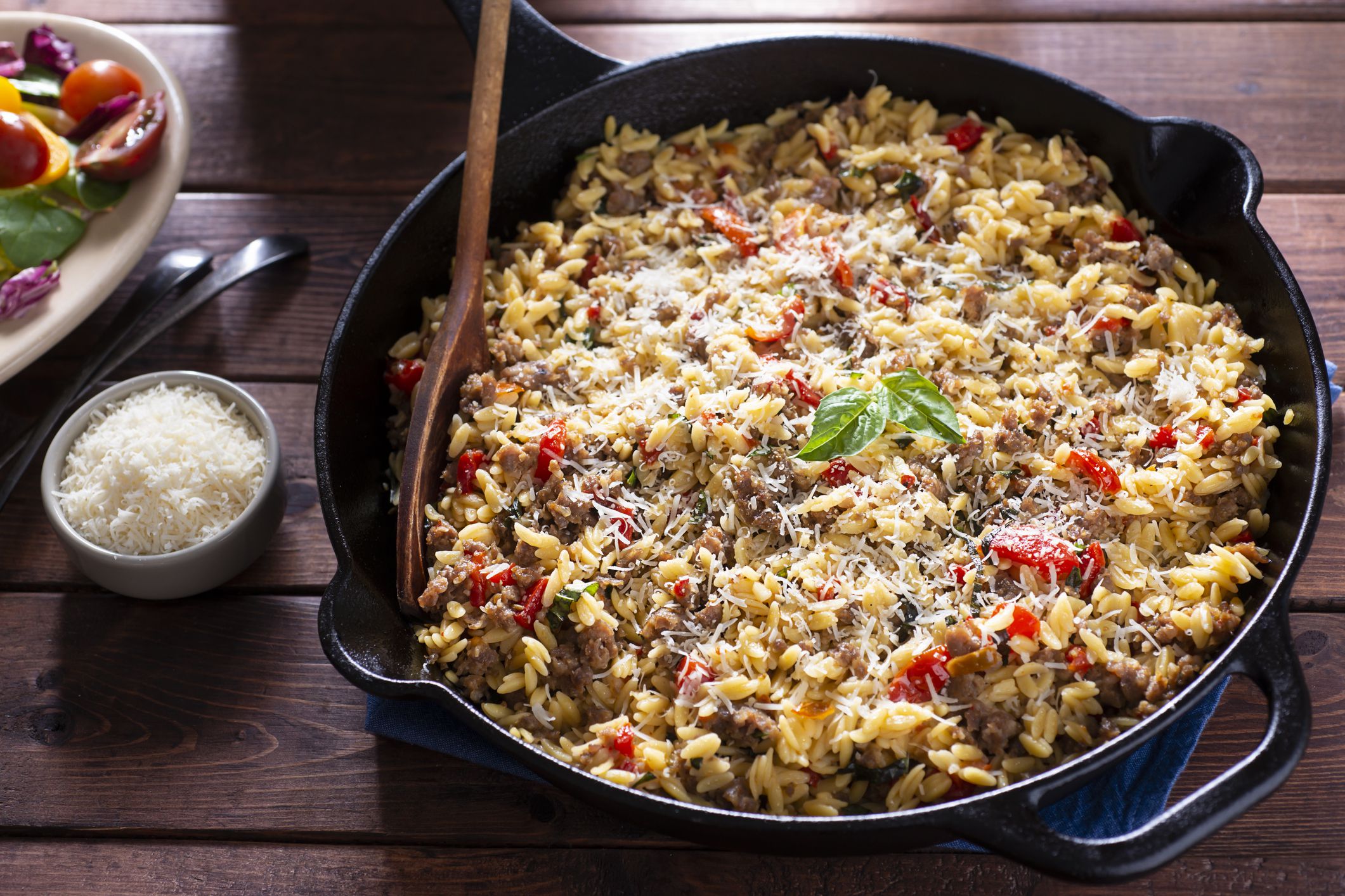 One-skillet Meal with Orzo, Italian Sausage, Roasted Red Pepper, Cherry Tomatoes, Parmesan Cheese and Basil.