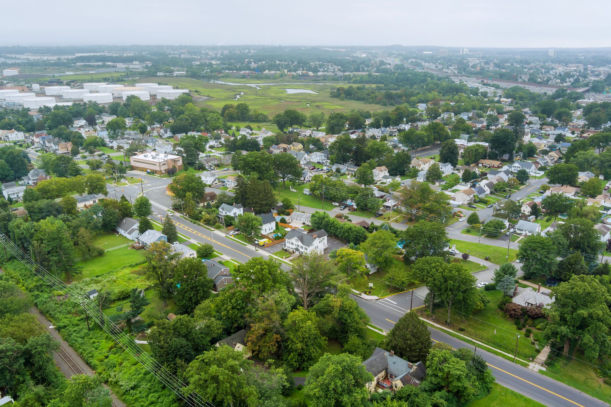 Panorama view over the small town landscape suburb homes sleeping area roof houses in Woodbridge NJ USA near oil refinery industrial tank
