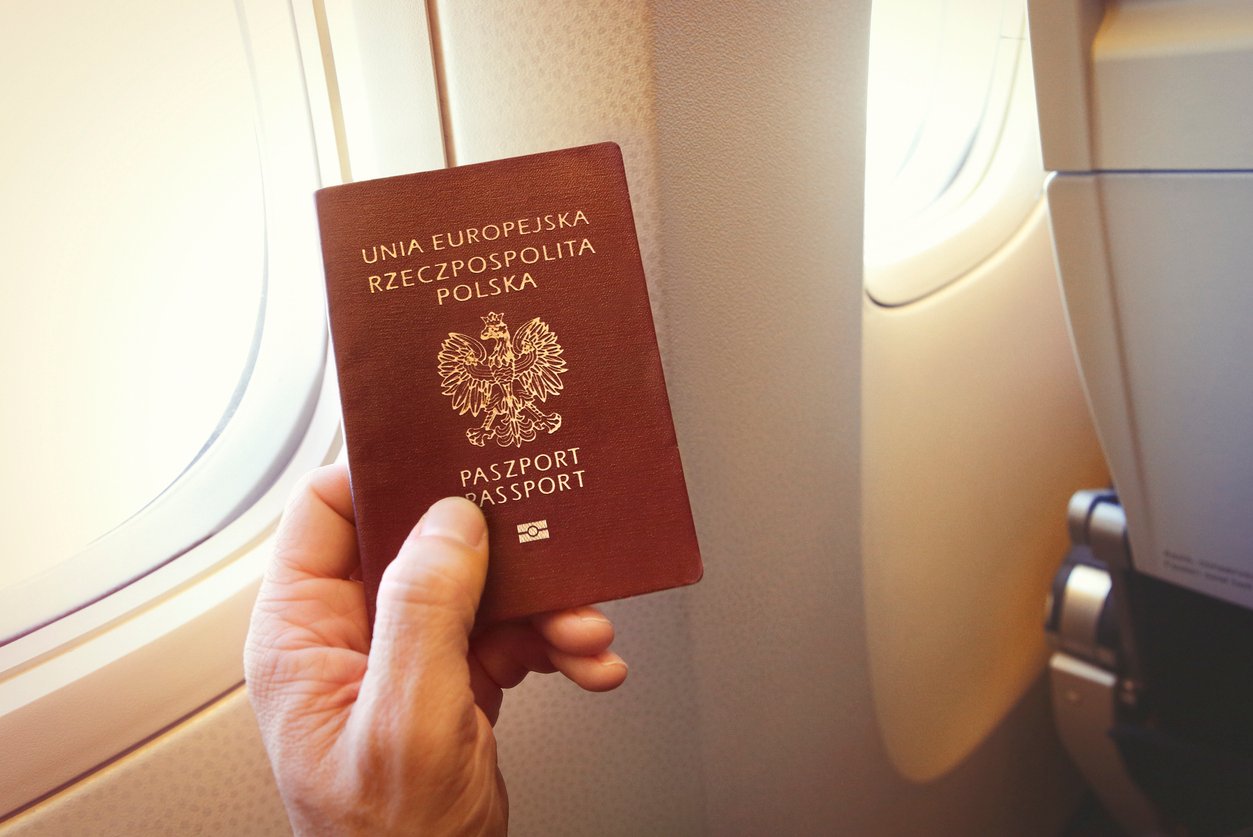 A hand holding a passport