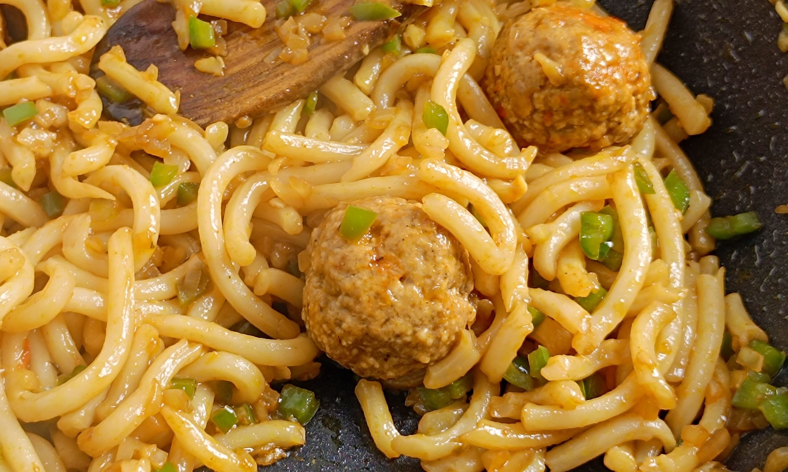 meatballs and noodles, close-up, on a plate
