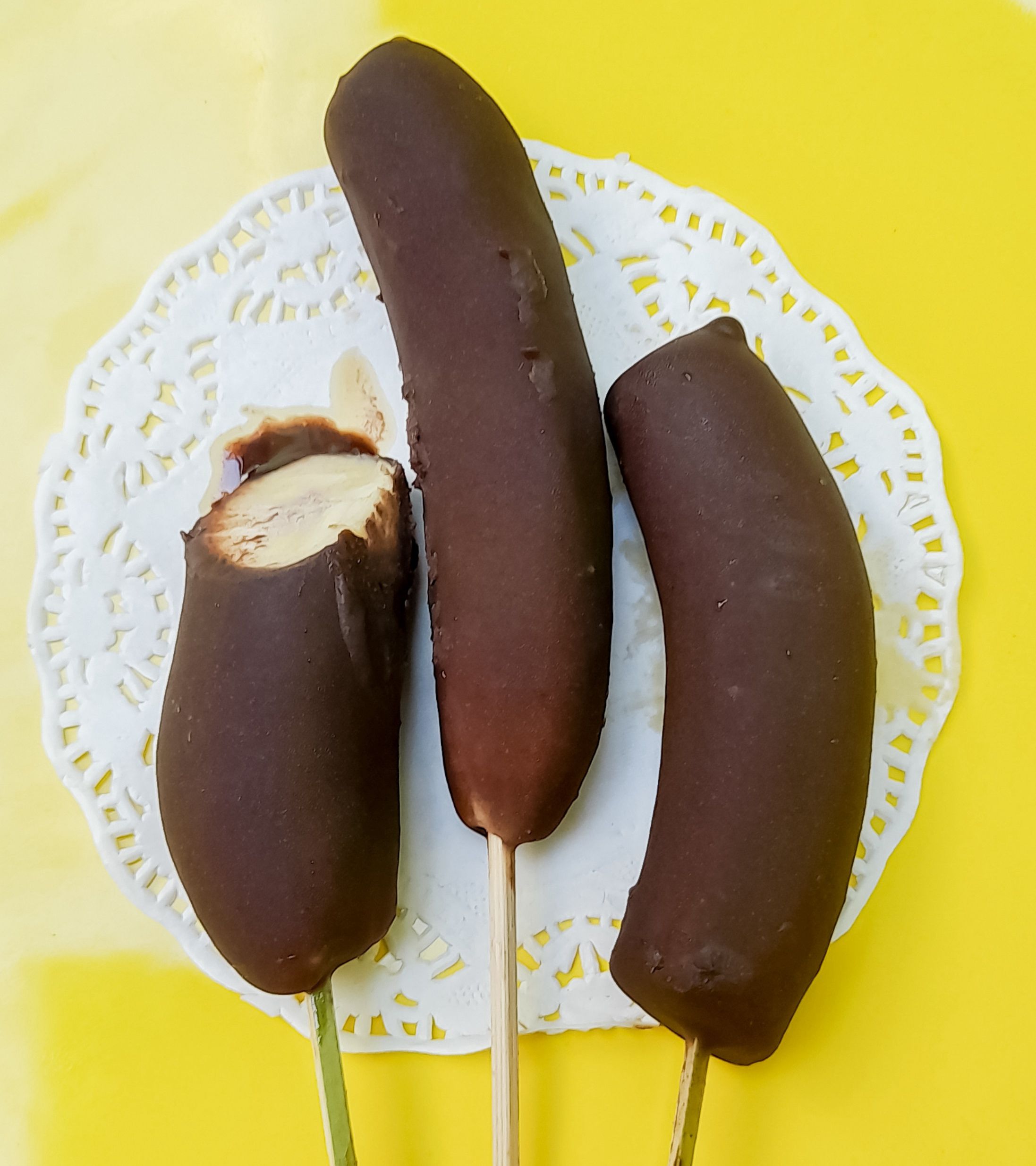 serving of chocolate bananas on a yellow plate, dessert, ready to eat