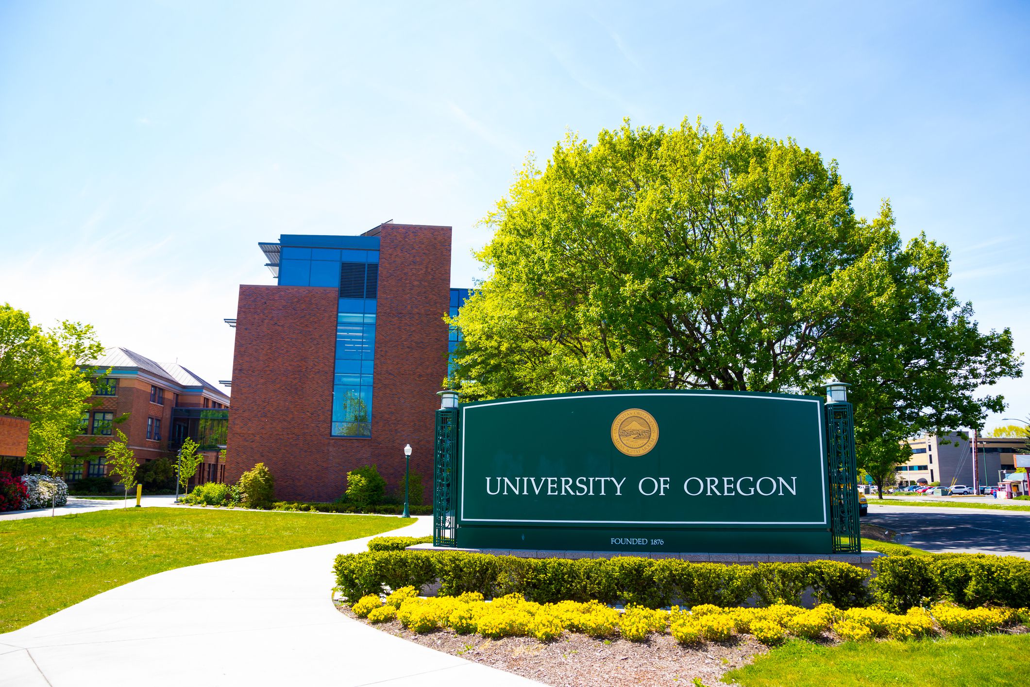 Eugene, OR, USA - April 29, 2014: University of Oregon campus entrance sign next to a walkway at the school.