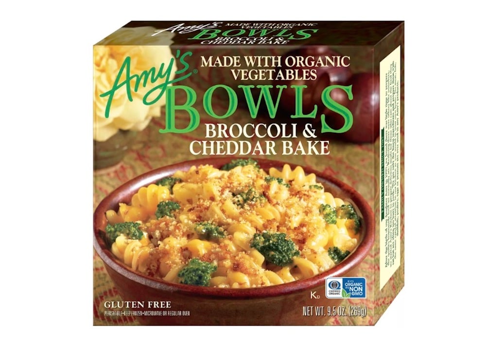 A box of Amy’s Bowls Broccoli & Cheddar Bake featuring a bowl of pasta with broccoli and cheese on the front. The packaging highlights that it’s gluten free and made with organic vegetables.