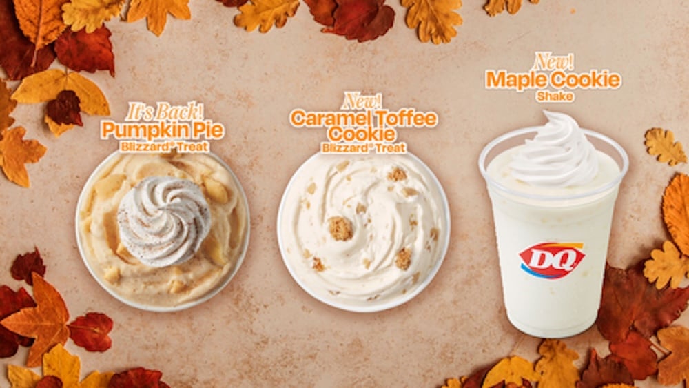 Three Dairy Queen fall-themed frozen desserts on a beige background with autumn leaves: Pumpkin Pie Blizzard, Caramel Toffee Cookie Blizzard, and a Maple Cookie Shake topped with whipped cream.