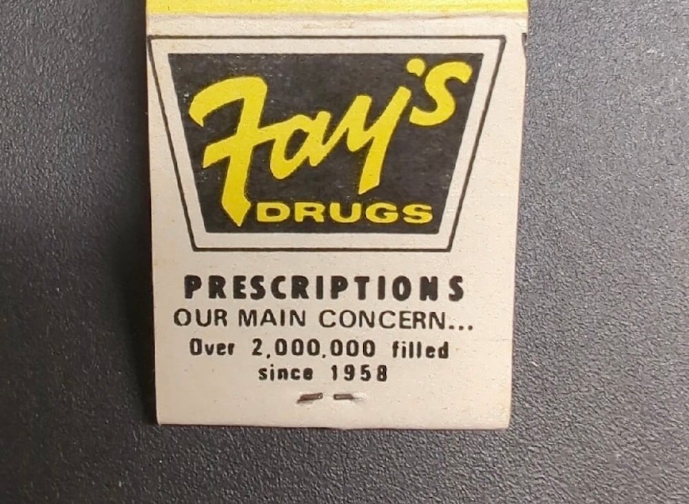 A matchbook cover with “Fay’s Drugs” in bold yellow letters. Below, it says: “Prescriptions our main concern... Over 2,000,000 filled since 1958.”