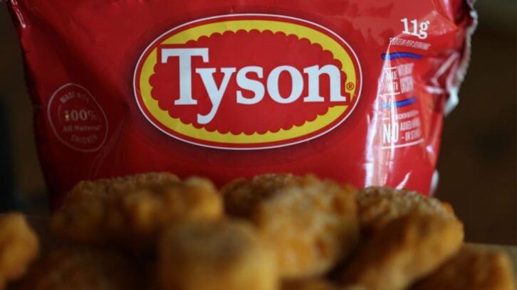 A red Tyson-branded bag is displayed in the background, with several breaded chicken nuggets placed in the foreground. The Tyson logo is prominently shown on the packaging.