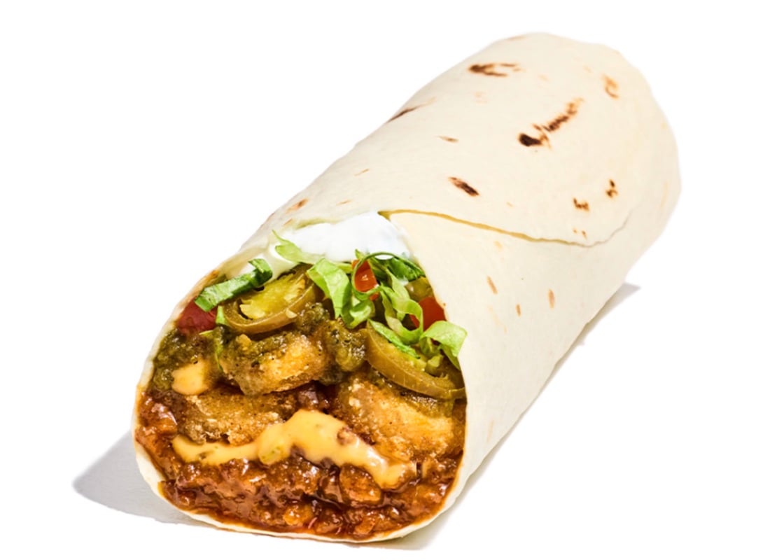 A close-up of a burrito from a new fast-food spot, filled with beef, melted cheese, jalapeño slices, lettuce, sauce, and sour cream, all wrapped in a flour tortilla on a white background.