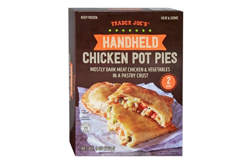 Box of Trader Joe’s Handheld Chicken Pot Pies, featuring an image of two golden-brown pies with visible chicken and vegetables inside. The packaging highlights “mostly dark meat chicken & vegetables.”