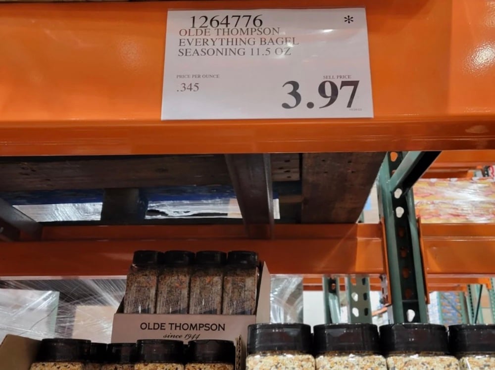A shelf displays several bottles of Olde Thompson Everything Bagel Seasoning, 11.5 oz, with a price sign above showing $3.97 each. The sign lists the price per ounce as .345 at Costco.